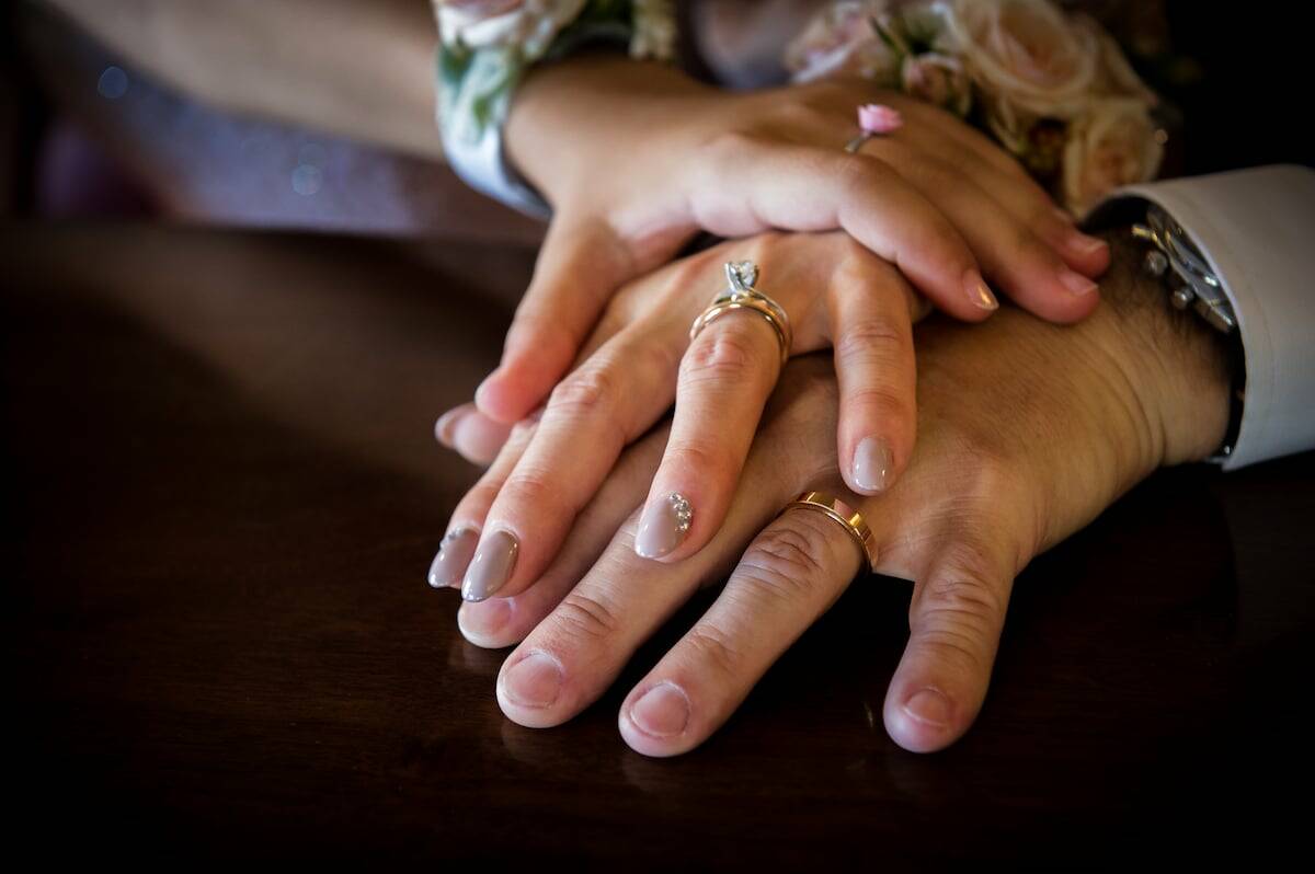 A mature couple in second marriage, with the daughter of the bride and her foster father.