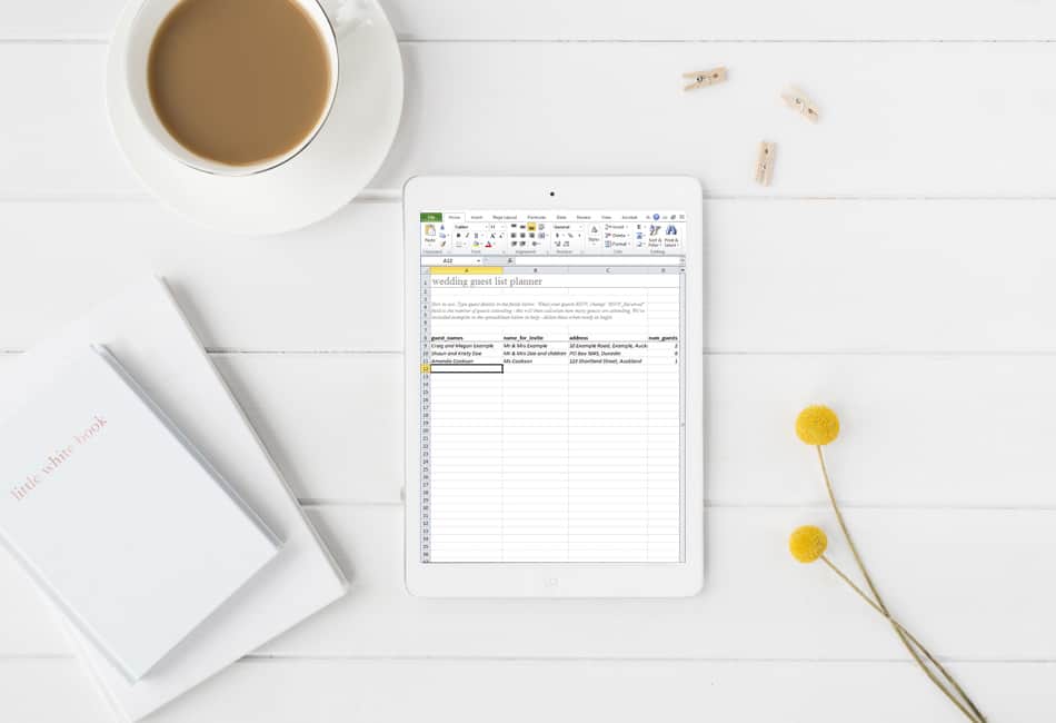 making a wedding guest list on ipad on table