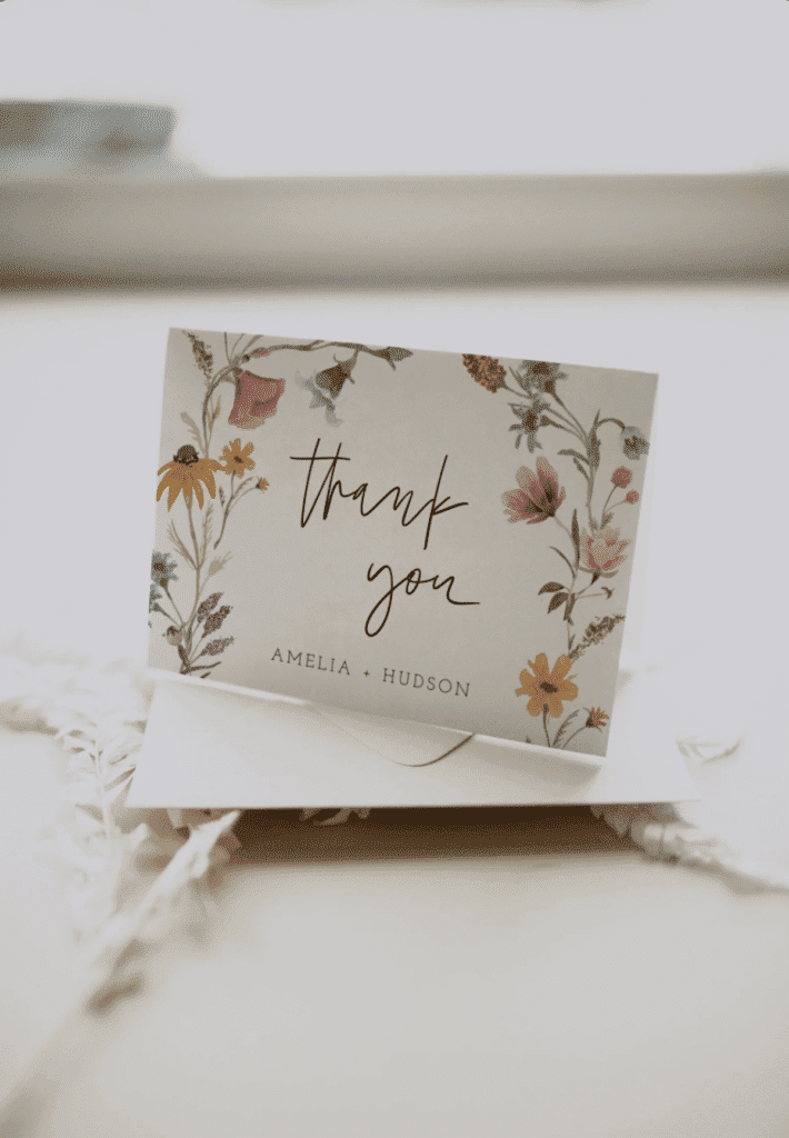 a thank you card with flowers on it.