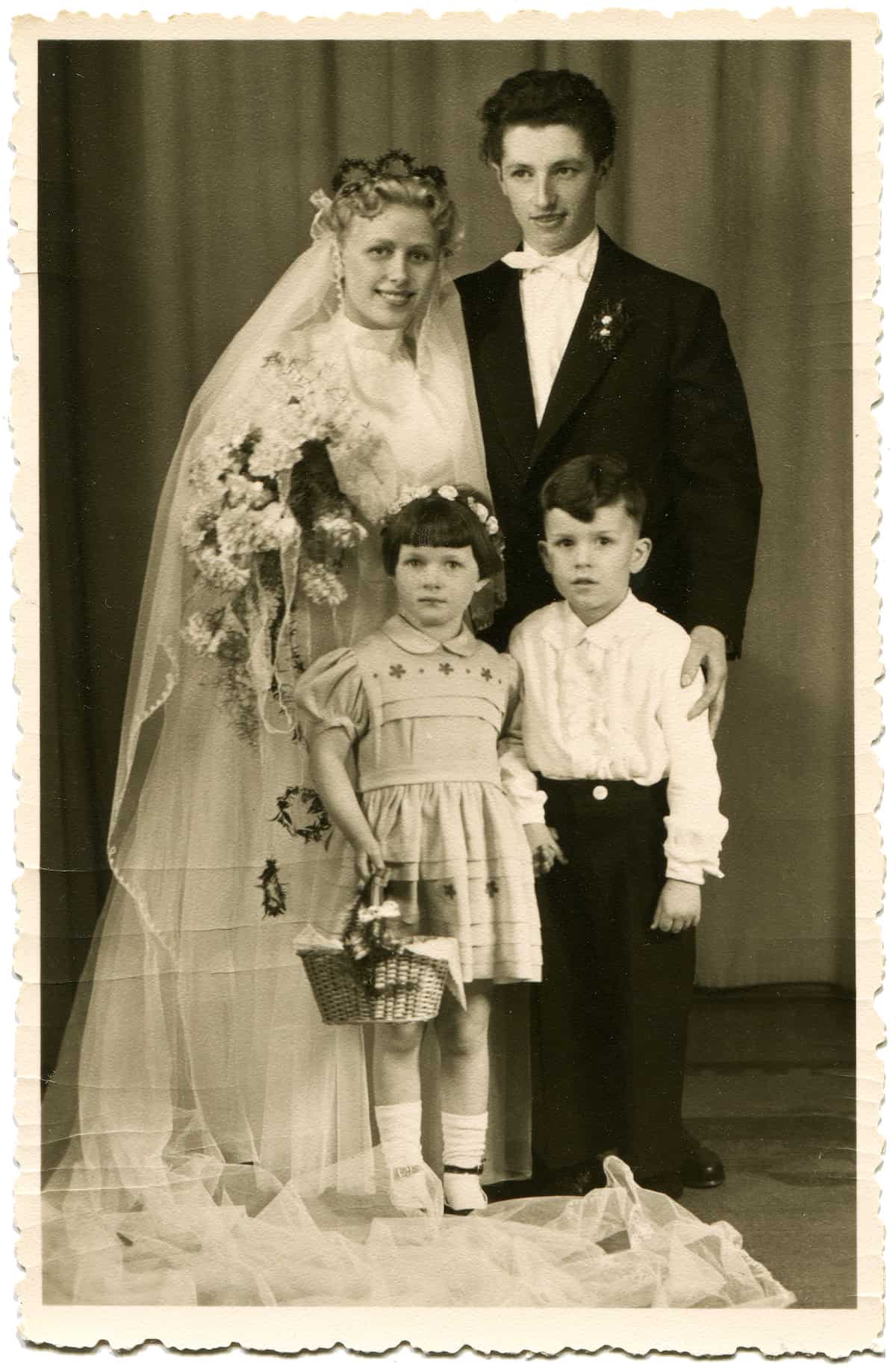 GERMANY - 1950s: An antique photo shows studio portrait of the bride and groom with a girl and a boy