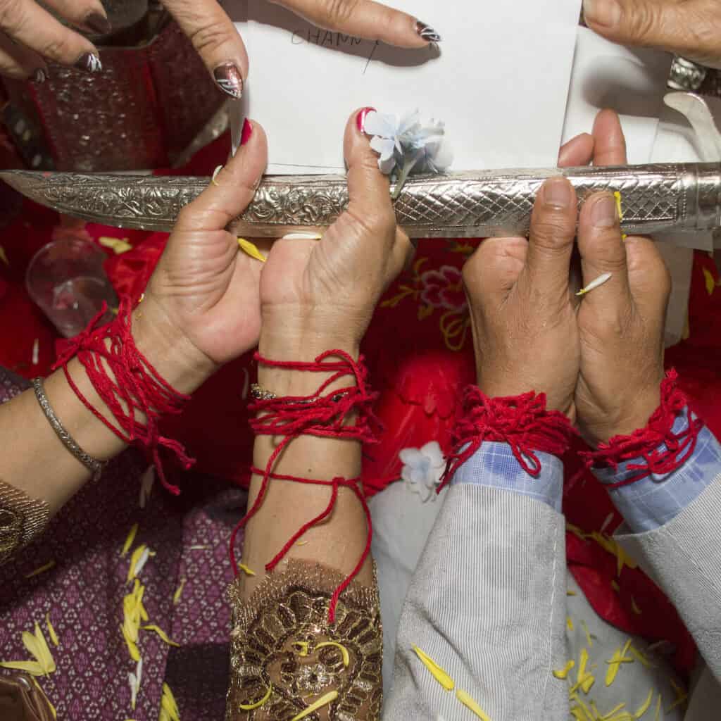 Cambodian Bride and Groom hands during ceremonial blessing